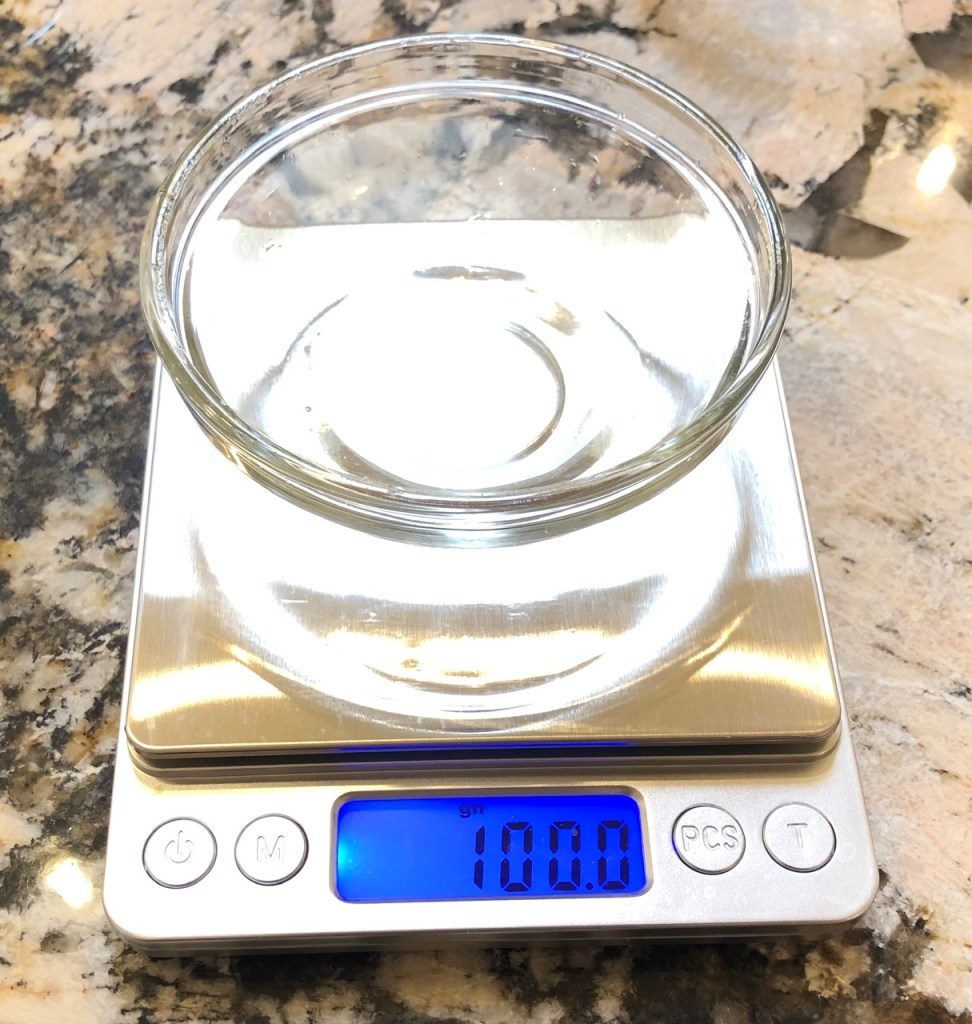 Measuring 100 grams of water.